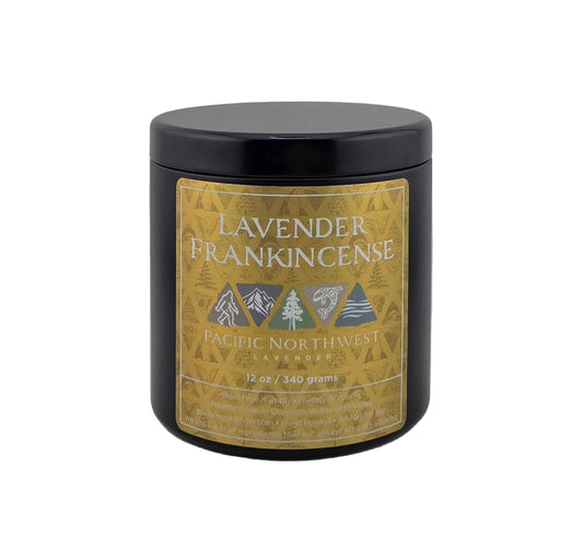 Black candle jar with a gold label featuring 'Lavender Frankincense' on a gray background